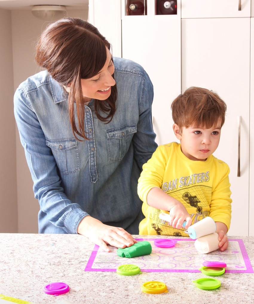 Image of millenial mother baking with her child