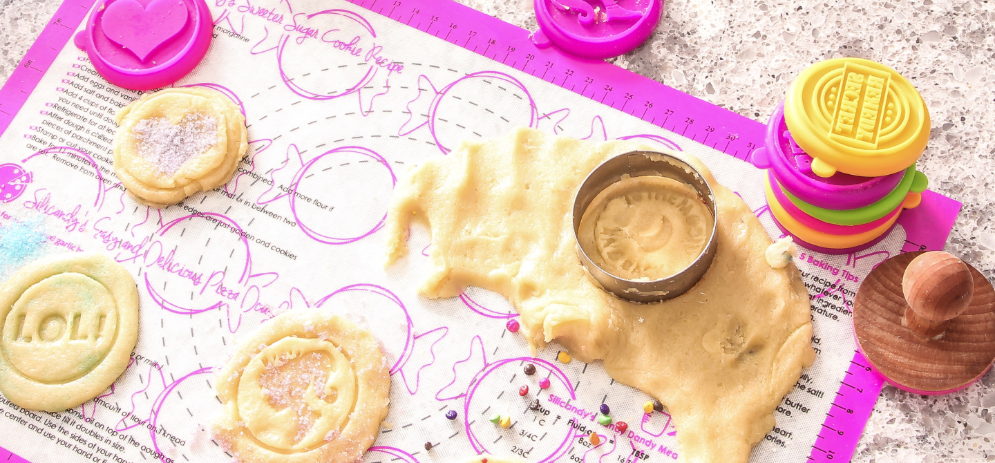 Image of baking mat with cookies and sprinkles on top